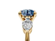 3 Stone Engagement Ring Setting for Fancy Blue Round Cut Center with Large Pear-Shaped Accents and Prong Head in Yellow Gold