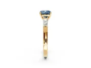 3 Stone Engagement Ring Setting for Fancy Blue Cushion Cut Center with Tapered Baguettes, Plain Band and Prong Head in Yellow Gold