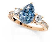 3 Stone Engagement Ring Setting for Fancy Blue Pear-Shaped Center with Round Cut Side Accents and Prong Head in Rose Gold