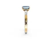 3 Stone Engagement Ring Setting for Fancy Blue Asscher Cut Center with Tapered Baguettes, Plain Band and Prong Head in Yellow Gold