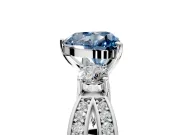 3 Stone Engagement Ring Setting for Fancy Blue Heart-Shaped Center with Pave Twist Band and Prong Head in Platinum