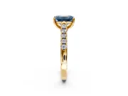 Solitaire Engagement Ring Setting for Fancy Blue Emerald Cut Center with Partway Pave Band and Prong Head in Yellow Gold
