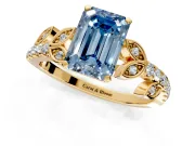 Leaf Motif Engagement Ring Setting for Fancy Blue Emerald Cut Center with Pave Band and Prong Head in Yellow Gold