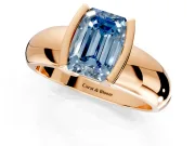 Tension Engagement Ring Setting for Fancy Blue Emerald Cut Center with Wide Flat Band and Tension Head in Rose Gold