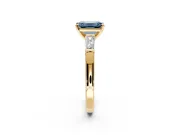 3 Stone Engagement Ring Setting for Fancy Blue Emerald Cut Center with Tapered Baguettes, Plain Band and Prong Head in Yellow Gold