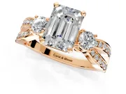 3 Stone Engagement Ring Setting for Emerald Cut Center with Pave Twist Band and Prong Head in Rose Gold