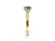 3 Stone Engagement Ring Setting for Fancy Blue Round Cut Center with Channel Baguette Accents and Prong Head in Yellow Gold