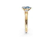 3 Stone Engagement Ring Setting for Fancy Blue Pear-Shaped Center with Wide Plain Band and Prong Head in Yellow Gold