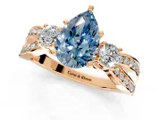 3 Stone Engagement Ring Setting for Fancy Blue Pear-Shaped Center with Pave Twist Band and Prong Head in Rose Gold
