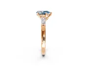 3 Stone Engagement Ring Setting for Fancy Blue Pear-Shaped Center with Tapered Baguettes, Plain Band and Prong Head in Rose Gold