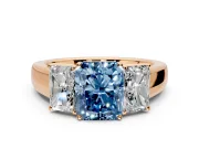 3 Stone Engagement Ring Setting for Fancy Blue Radiant Cut Center with Raised Basket Heads and Prong Head in Rose Gold