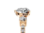 3 Stone Engagement Ring Setting for Heart-Shaped Center with Round Cut Side Accents and Prong Head in Rose Gold