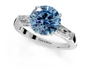 3 Stone Engagement Ring Setting for Fancy Blue Round Cut Center with Tapered Baguettes, Plain Band and Prong Head in Sterling Silver