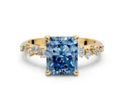Solitaire Engagement Ring Setting for Fancy Blue Radiant Cut Center with Trailing Leaf Accent Band and Prong Head in Yellow Gold