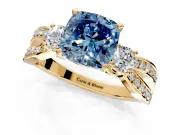 3 Stone Engagement Ring Setting for Fancy Blue Cushion Cut Center with Pave Twist Band and Prong Head in Yellow Gold