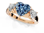 3 Stone Engagement Ring Setting for Fancy Blue Heart-Shaped Center with Raised Basket Heads and Prong Head in Rose Gold