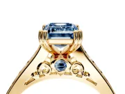 Solitaire Engagement Ring Setting for Fancy Blue Emerald Cut Center with Channel Band and Double Claw Prong Head in Yellow Gold