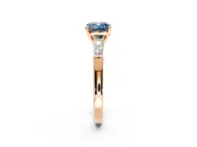 3 Stone Engagement Ring Setting for Fancy Blue Cushion Cut Center with Tapered Baguettes, Plain Band and Prong Head in Rose Gold