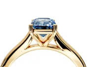 Solitaire Engagement Ring Setting for Fancy Blue Emerald Cut Center with Narrow Cathedral Band and Prong Head in Yellow Gold