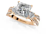 3 Stone Engagement Ring Setting for Princess Cut Center with Pave Twist Band and Prong Head in Rose Gold