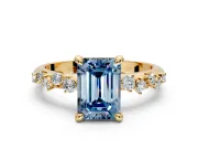 Solitaire Engagement Ring Setting for Fancy Blue Emerald Cut Center with Trailing Leaf Accent Band and Prong Head in Yellow Gold