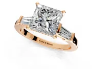 3 Stone Engagement Ring Setting for Princess Cut Center with Channel Baguette Accents and Prong Head in Rose Gold