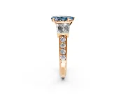 Channel-Set Engagement Ring Setting for Fancy Blue Pear-Shaped Center with Baguette Band and Prong Head in Rose Gold