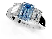 3 Stone Engagement Ring Setting for Fancy Blue Emerald Cut Center with Raised Basket Heads and Prong Head in Platinum