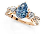 3 Stone Engagement Ring Setting for Fancy Blue Pear-Shaped Center with Pave Split Shank and Prong Head in Rose Gold