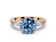 3 Stone Engagement Ring Setting for Fancy Blue Round Cut Center with Tapered Baguettes, Plain Band and Prong Head in Rose Gold