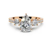 3 Stone Engagement Ring Setting for Pear-Shaped Center with Round Cut Side Accents and Prong Head in Rose Gold