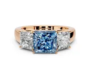 3 Stone Engagement Ring Setting for Fancy Blue Princess Cut Center with Raised Basket Heads and Prong Head in Rose Gold