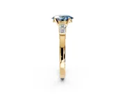 3 Stone Engagement Ring Setting for Fancy Blue Oval Center with Channel Baguette Accents and Prong Head in Yellow Gold