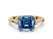 3 Stone Engagement Ring Setting for Fancy Blue Asscher Cut Center with Low-Set Round Cut Accents and Prong Head in Yellow Gold