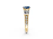 Channel-Set Engagement Ring Setting for Fancy Blue Round Cut Center with Baguette Band and Prong Head in Yellow Gold