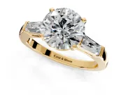 3 Stone Engagement Ring Setting for Round Cut Center with Tapered Baguettes, Plain Band and Prong Head in Yellow Gold