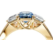 3 Stone Engagement Ring Setting for Fancy Blue Emerald Cut Center with Raised Basket Heads and Prong Head in Yellow Gold