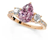 3 Stone Engagement Ring Setting for Fancy Pink Pear-Shaped Center with Round Cut Side Accents and Prong Head in Rose Gold