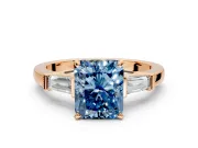 3 Stone Engagement Ring Setting for Fancy Blue Radiant Cut Center with Channel Baguette Accents and Prong Head in Rose Gold