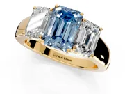 3 Stone Engagement Ring Setting for Fancy Blue Emerald Cut Center with Raised Basket Heads and Prong Head in Yellow Gold