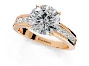 Solitaire Engagement Ring Setting for Round Cut Center with Princess Cut Channel Band and Prong Head in Rose Gold