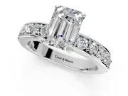Solitaire Engagement Ring Setting for Emerald Cut Center with Channel-Set Accents and Prong Head in Platinum