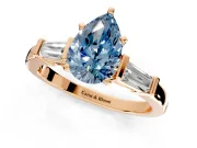 3 Stone Engagement Ring Setting for Fancy Blue Pear-Shaped Center with Channel Baguette Accents and Prong Head in Rose Gold