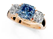 3 Stone Engagement Ring Setting for Fancy Blue Cushion Cut Center with Raised Basket Heads and Prong Head in Rose Gold