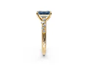 Solitaire Engagement Ring Setting for Fancy Blue Emerald Cut Center with Trailing Leaf Accent Band and Prong Head in Yellow Gold