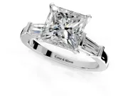 3 Stone Engagement Ring Setting for Princess Cut Center with Channel Baguette Accents and Prong Head in Platinum