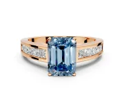 Solitaire Engagement Ring Setting for Fancy Blue Emerald Cut Center with Princess Cut Channel Band and Prong Head in Rose Gold