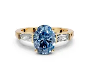 3 Stone Engagement Ring Setting for Fancy Blue Oval Center with Tapered Baguettes, Plain Band and Prong Head in Yellow Gold