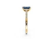 Solitaire Engagement Ring Setting for Fancy Blue Emerald Cut Center with Channel Accents and Prong Head in Yellow Gold