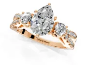 3 Stone Engagement Ring Setting for Pear-Shaped Center with Pave Split Shank and Prong Head in Rose Gold